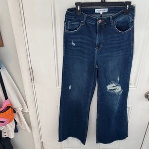 Trendy Dark Blue Distressed Women's Flare Jeans with an inseam of 28"